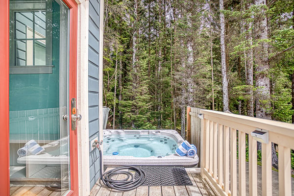 Your private hot tub awaits on this secluded deck, nestled among tall evergreens for the ultimate forest retreat and peaceful soak.